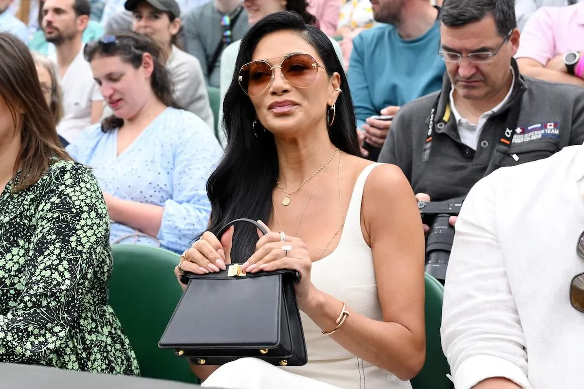 Wearing a cream dress and gold jewelry, Nicole Scherzinger sits front row at Wimbledon 2024