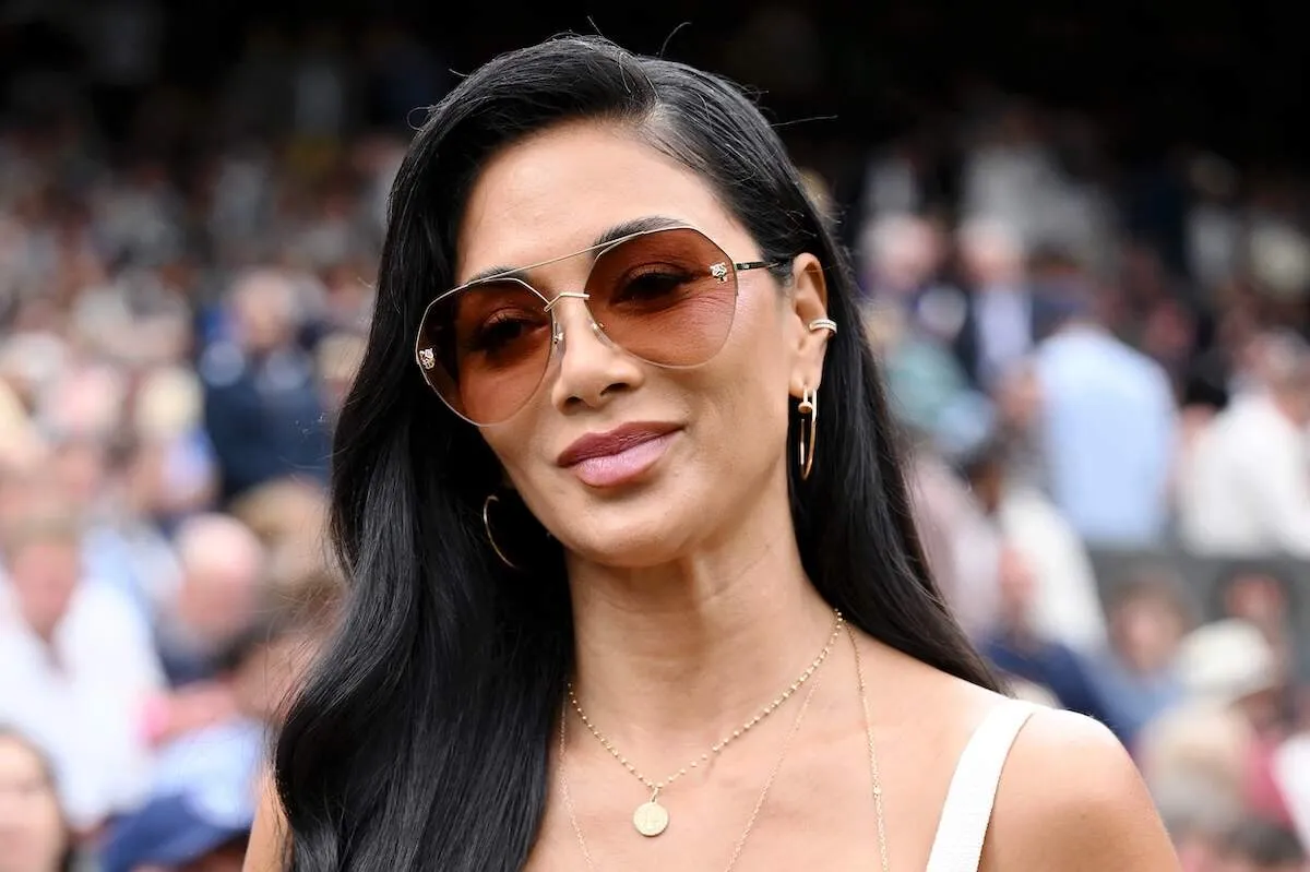 Wearing a cream dress and gold jewelry, Nicole Scherzinger sits front row at Wimbledon 2024