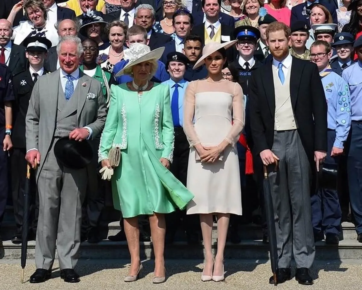 Now-King Charles, Camilla Parker Bowles, Meghan Markle, and Prince Harry pose for photo during Charles' 70th Birthday Garden Party at Buckingham Palace