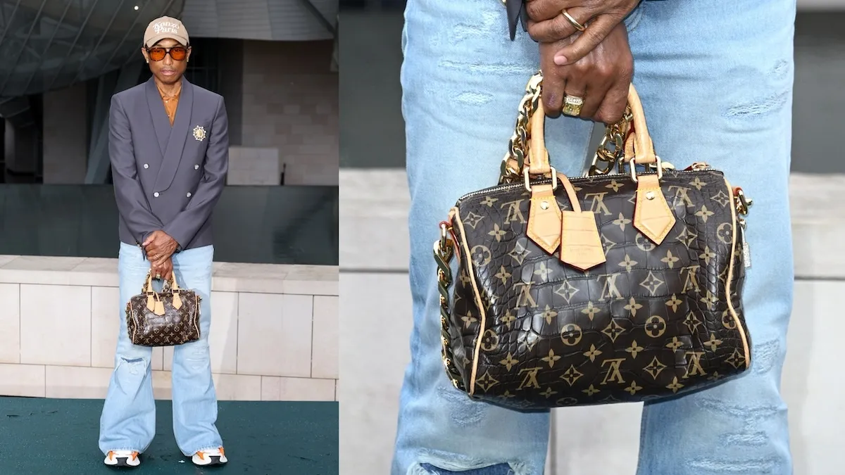 Rapper Pharrell Williams wears a navy blazer and carries a Louis Vuitton bag at The Prelude To The Olympics