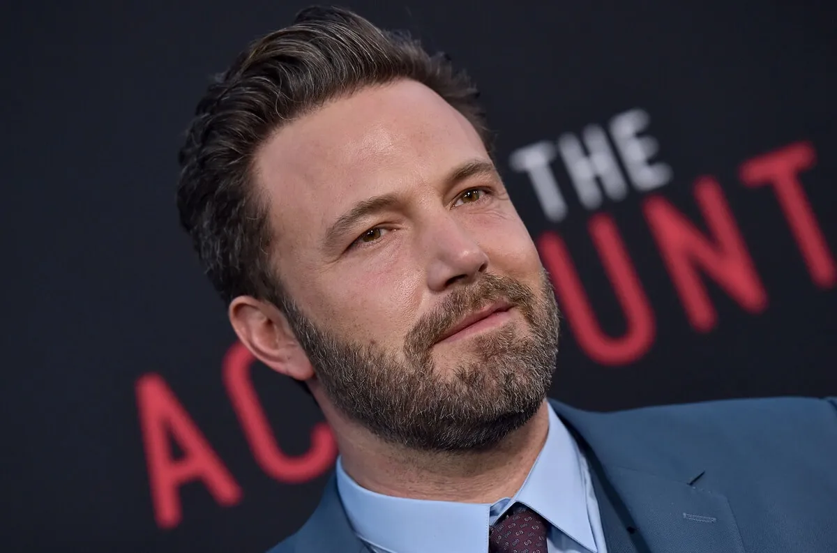 Ben Affleck posing in a blue suit at 'The Accountant' premiere.