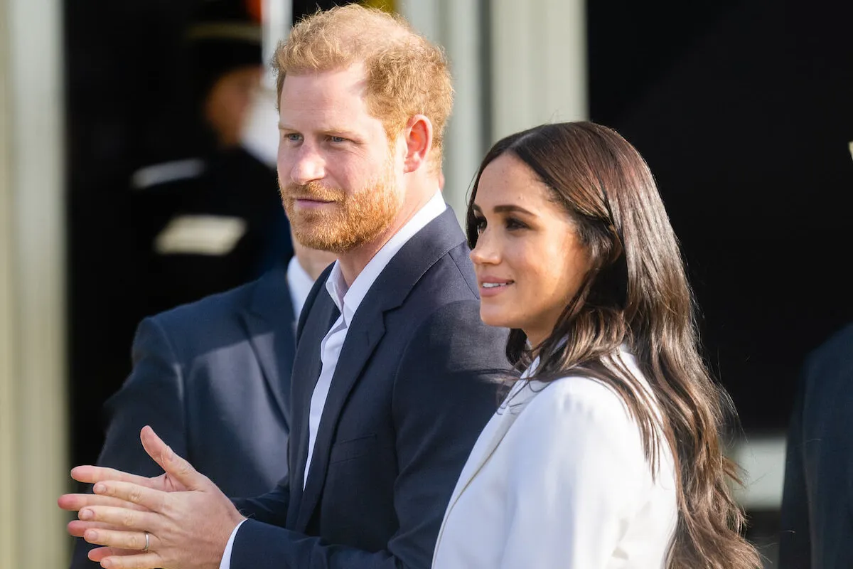 Prince Harry and Meghan Markle, whose former UK home, Frogmore Cottage, is vacant, look on at an Invictus Games event