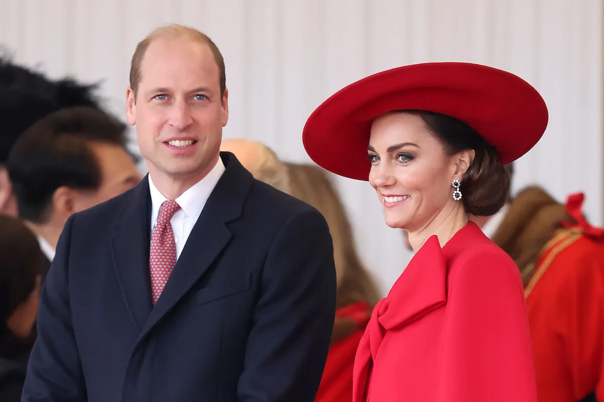 Prince William and Kate Middleton, whose seen a change in Prince William's parenting, smile and look on