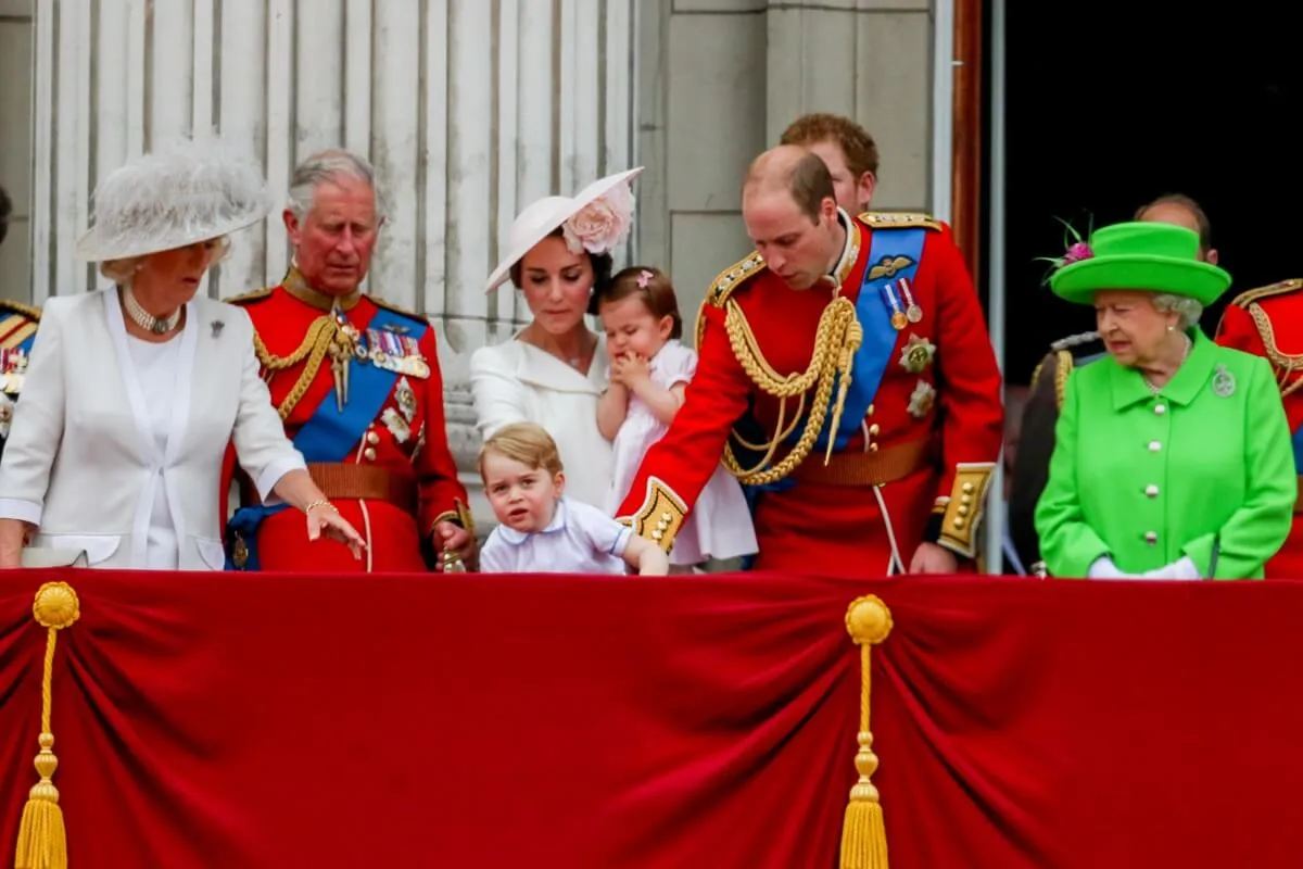 Prince William grabs Prince George so he doesnt fall as members of the royal family gather on the Buckingham Palace balcony during Trooping the Colour