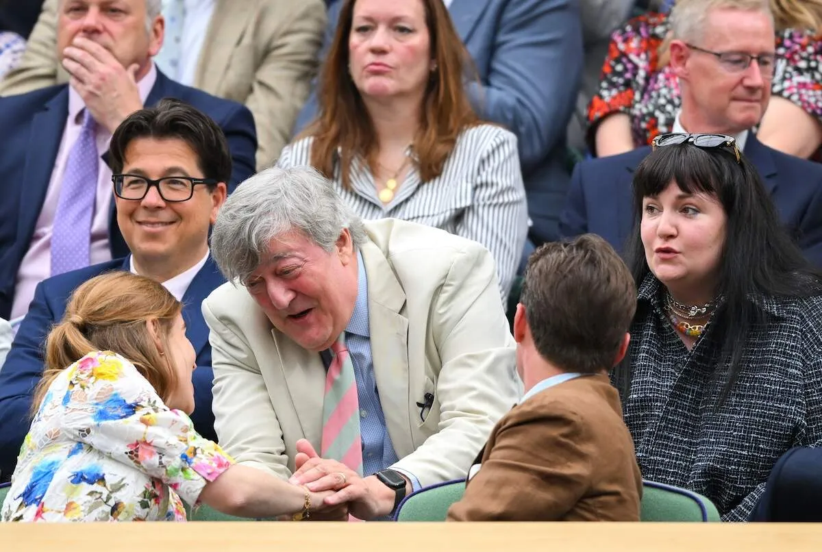 Wearing a floral dress, Princess Beatrice talks with Michael McIntyre and Lena Dunham front row at Wimbledon