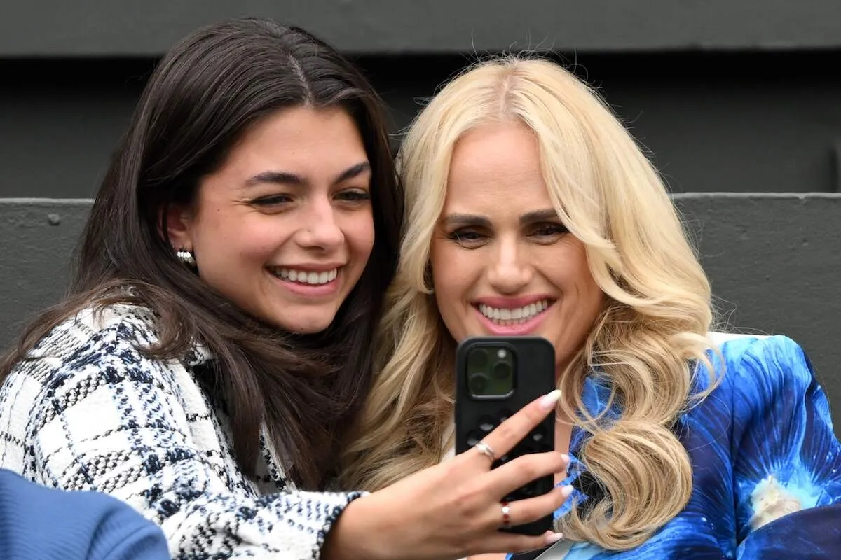 Actor Rebel Wilson takes a pic with a fellow spectator during day two of the Wimbledon Tennis Championships