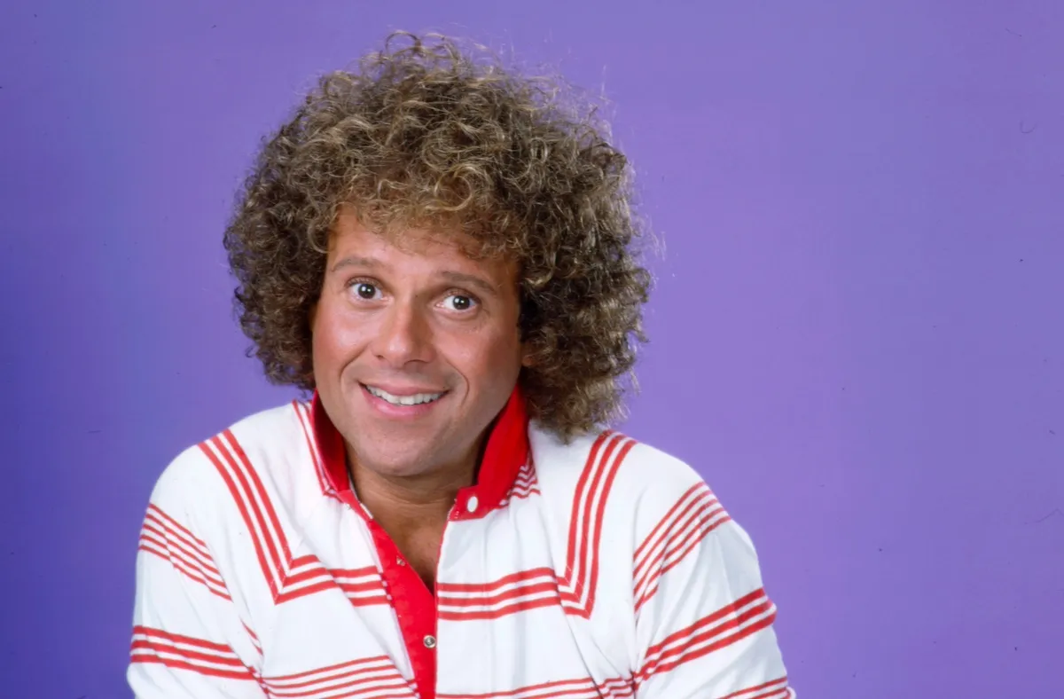Portrait of smiling Richard Simmons in a red and white polo shirt