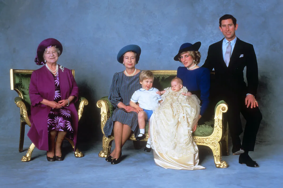 King Charles, who made a comment at Prince Harry's christening, sits with other royals.