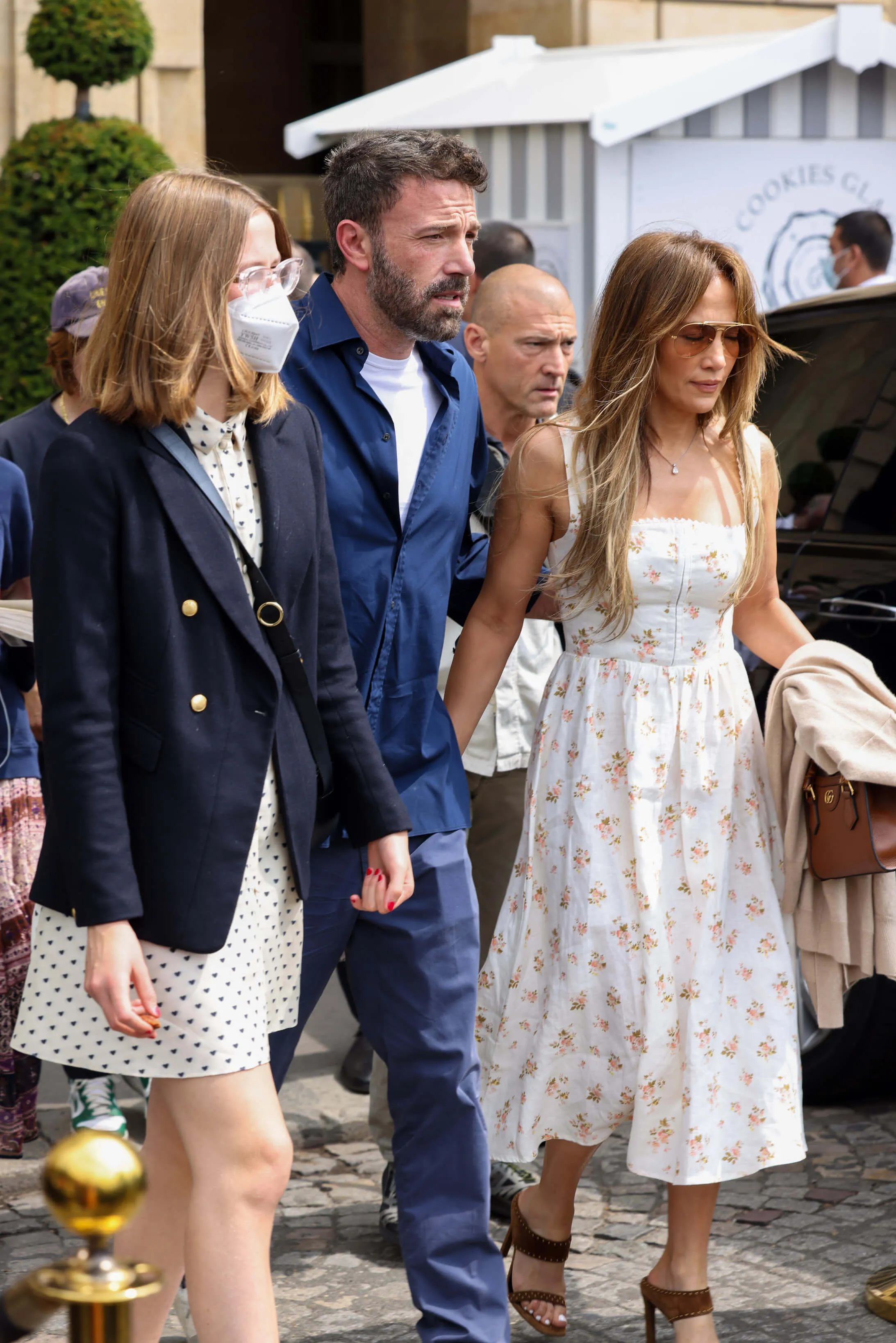 Violet Affleck, Ben Affleck, and Jennifer Lopez walking next to each other from their hotel on July 23, 2022, in Paris, France