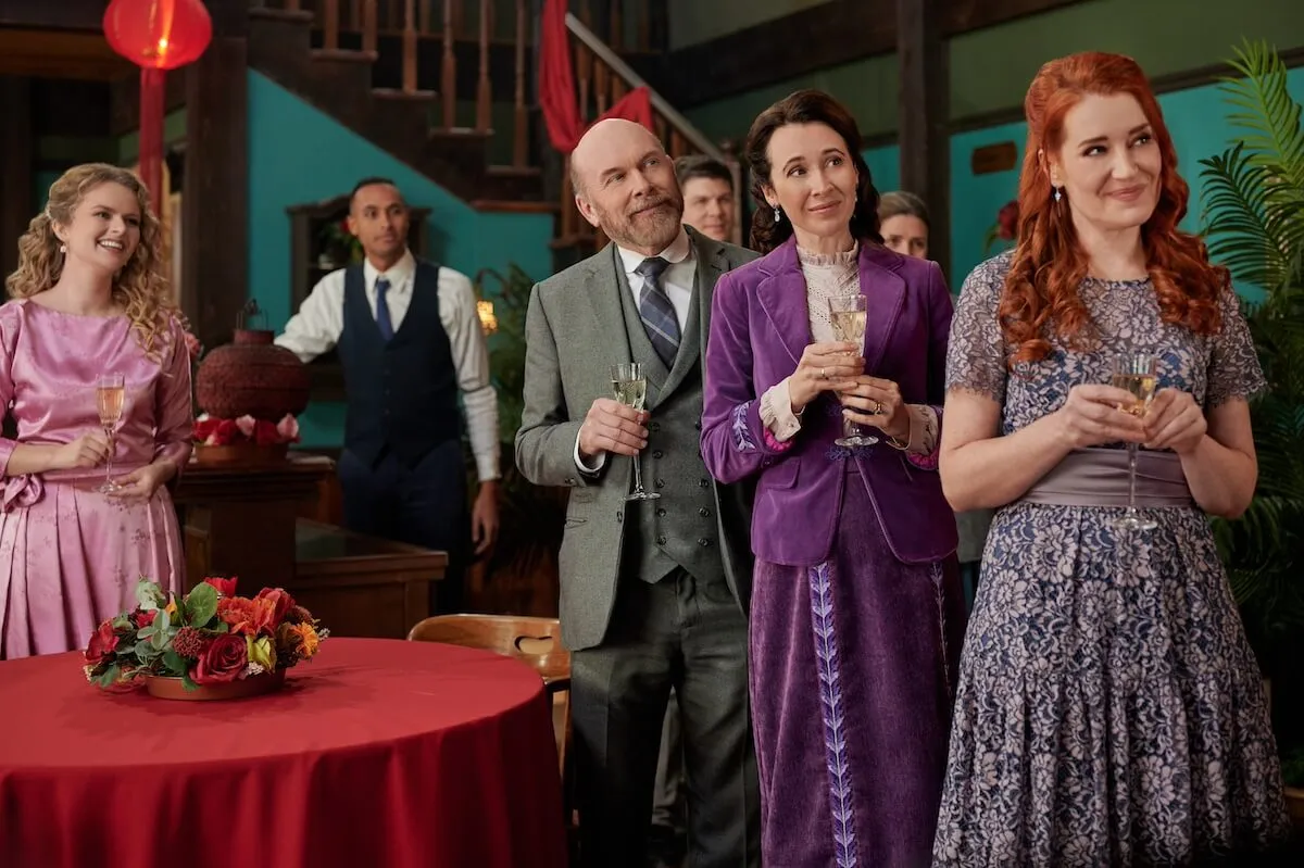 Faith, Ned, Florence, and Molly smiling and standing in the saloon in the 'When Calls the Heart' Season 11 finale