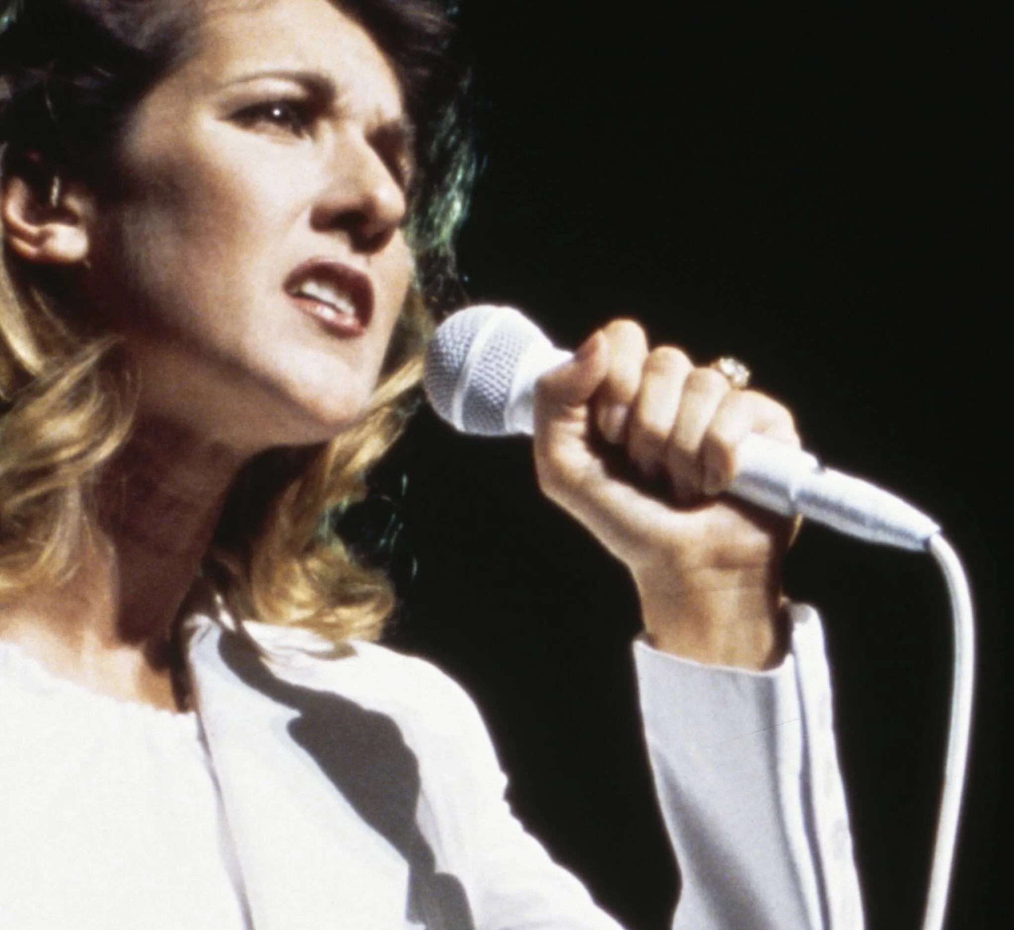 "Because You Loved Me' singer Celine Dion with a microphone