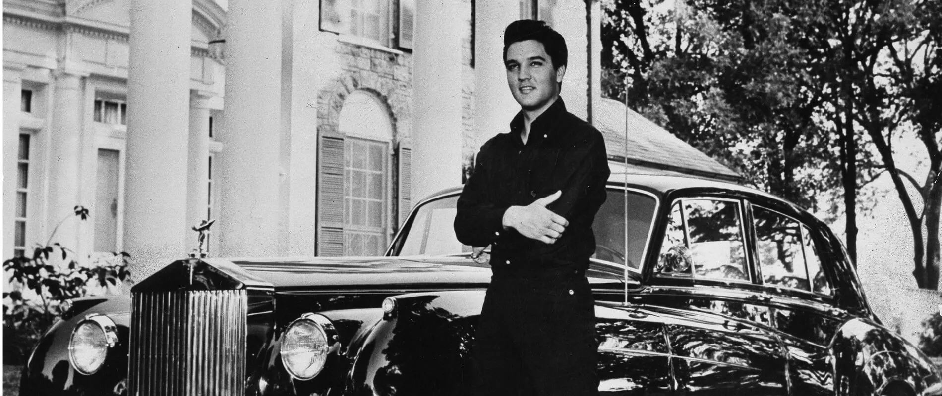 Elvis Presley photographed in front of his Graceland home