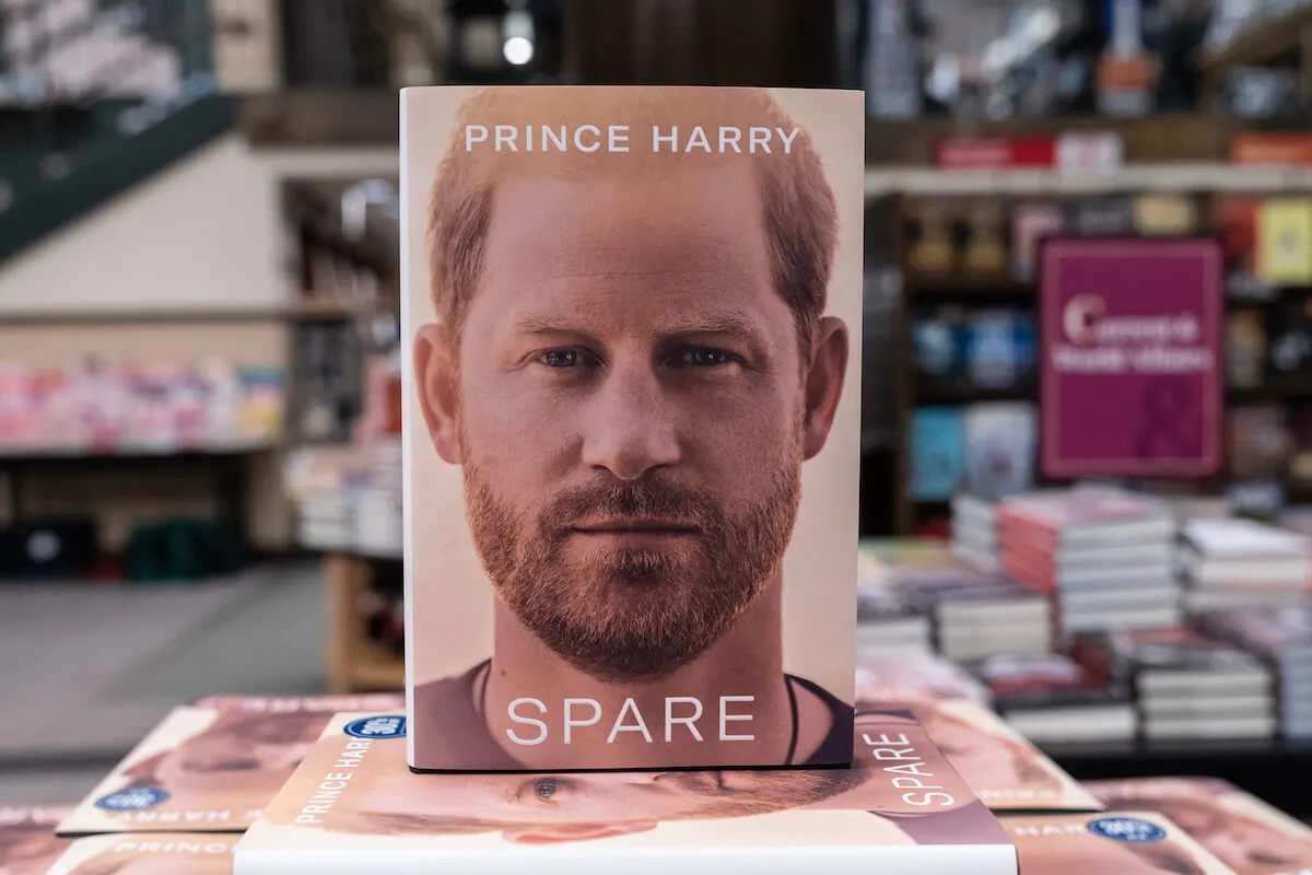 A hardcover copy of 'Spare,' which is being released in paperback, sits on a table.