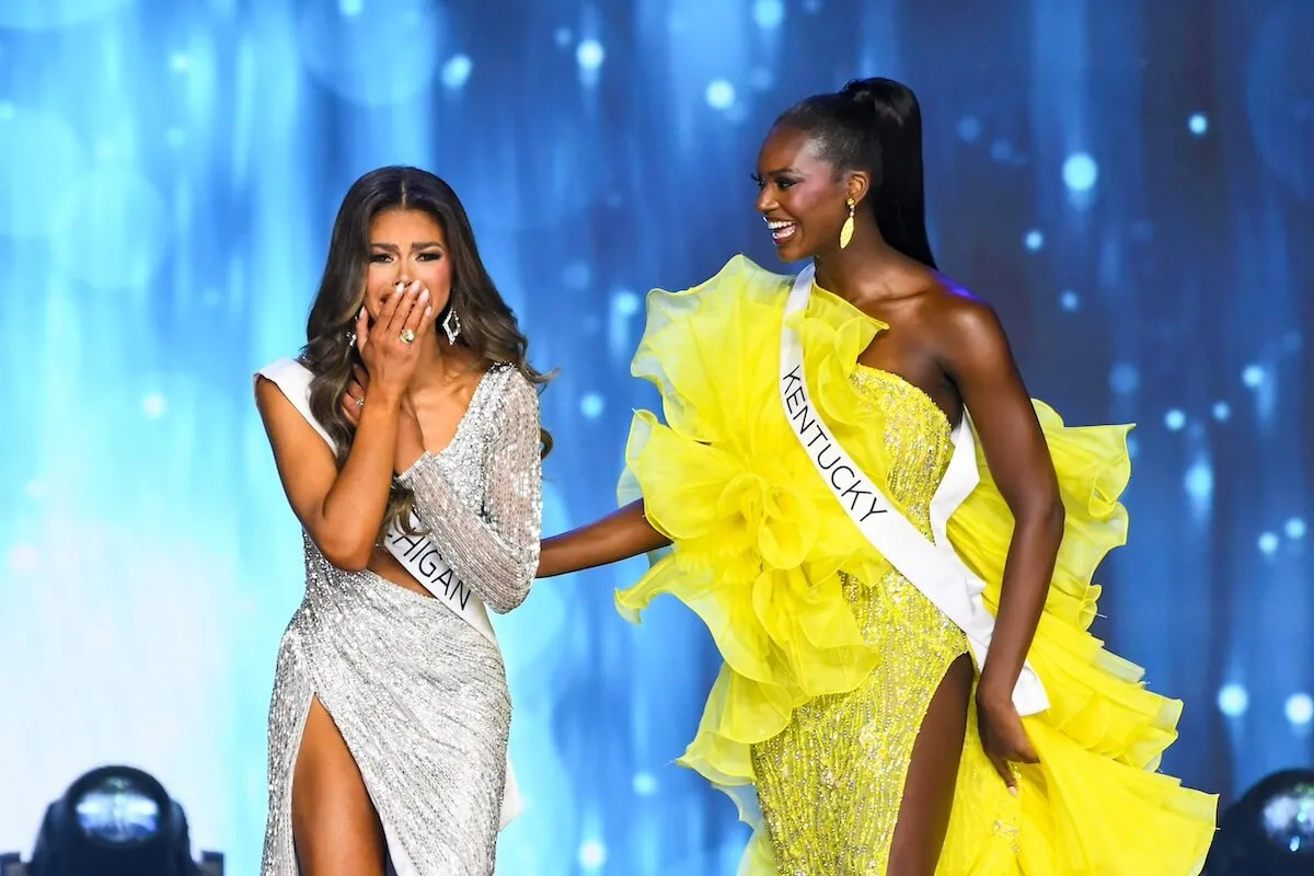 Miss Kentucky, in yellow, stands by as Alma Cooper reacts to winning Miss USA