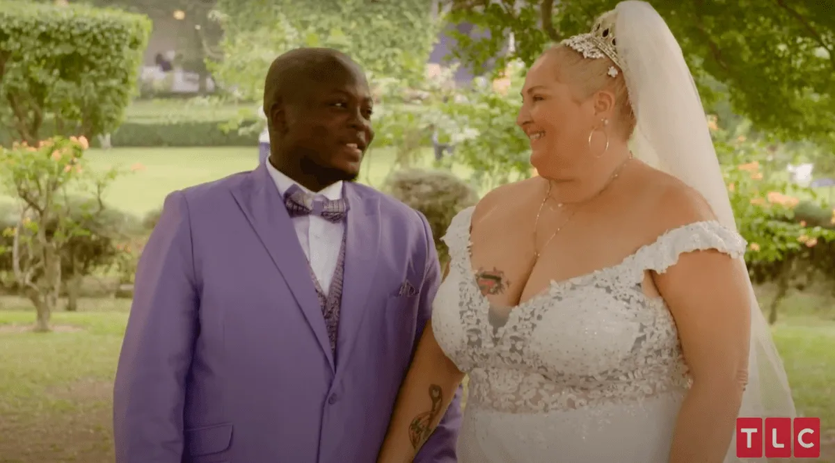 Angela Deem and Michael Ilesanmi looking at each other and smiling on their wedding day on '90 Day Fiance'