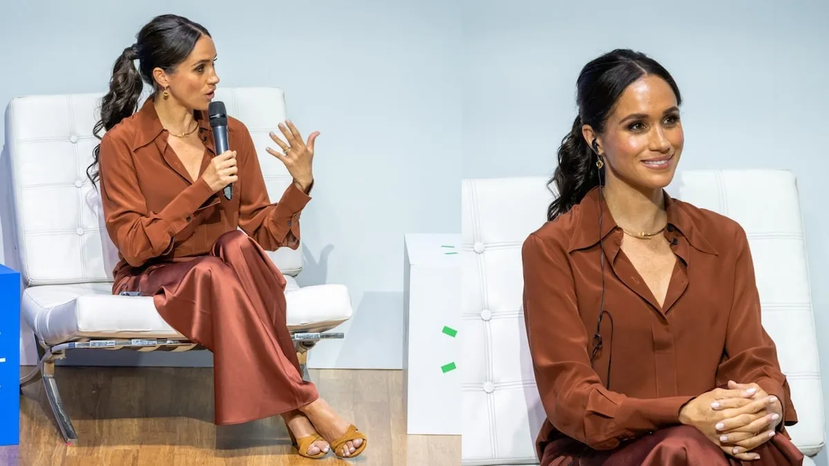 Wearing a rust brown skirt and matching top, Meghan Markle speaks onstage in Columbia