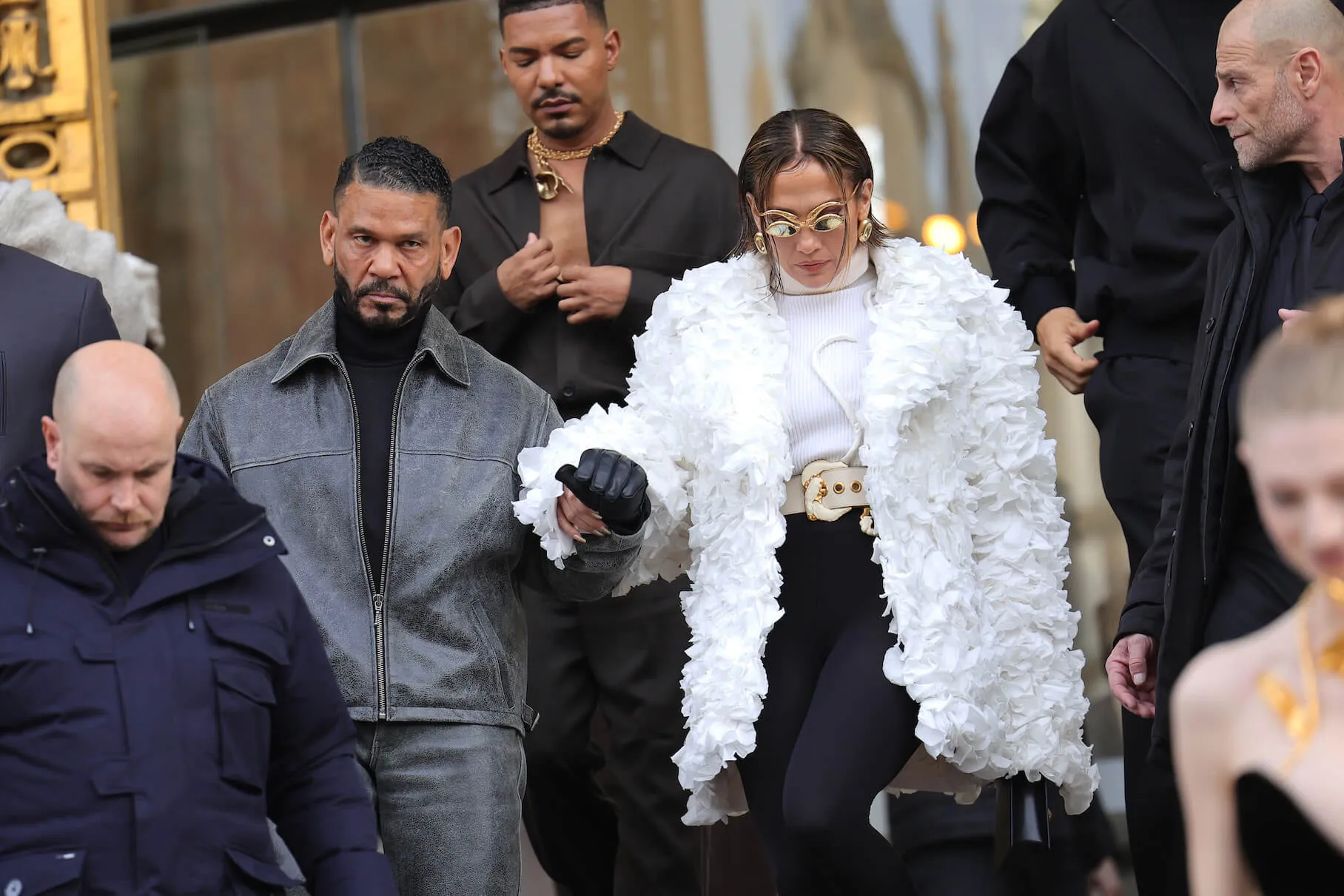 Benny Medina and Jennifer Lopez holding hands in a crowd at Paris Fashion Week in 2024