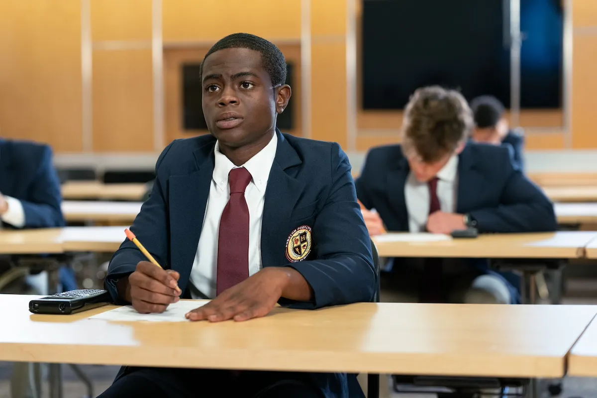 Akili McDowell wearing a blazer and sitting at a desk in 'David Makes Man'