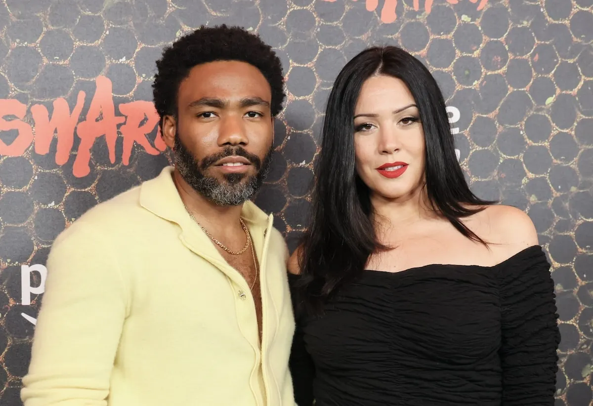 Couple Donald Glover and Michelle White make their first red carpet appearance in a yellow suit and black dress