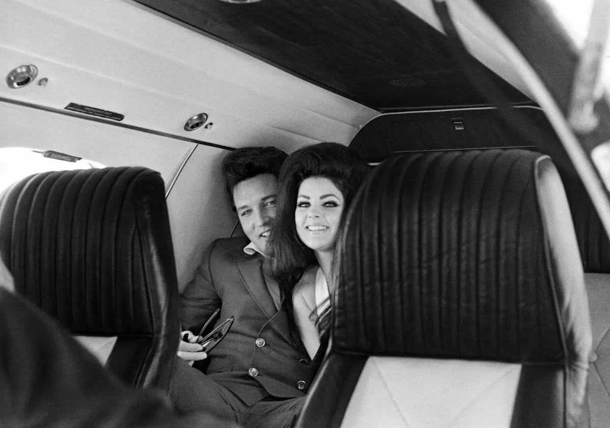 Black and white photo of Elvis and Priscilla Presley on a plance