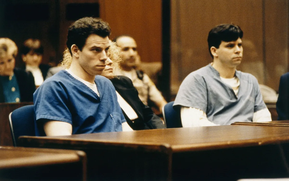 The Menendez brothers wearing prison jumpsuits sitting in court