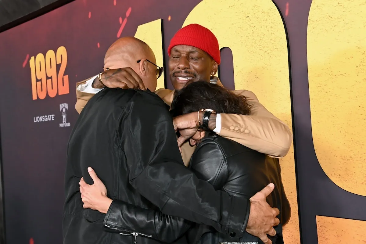 Friends Vin Diesel, Michelle Rodriguez and Tyrese Gibson hug each other on the 1992 red carpet