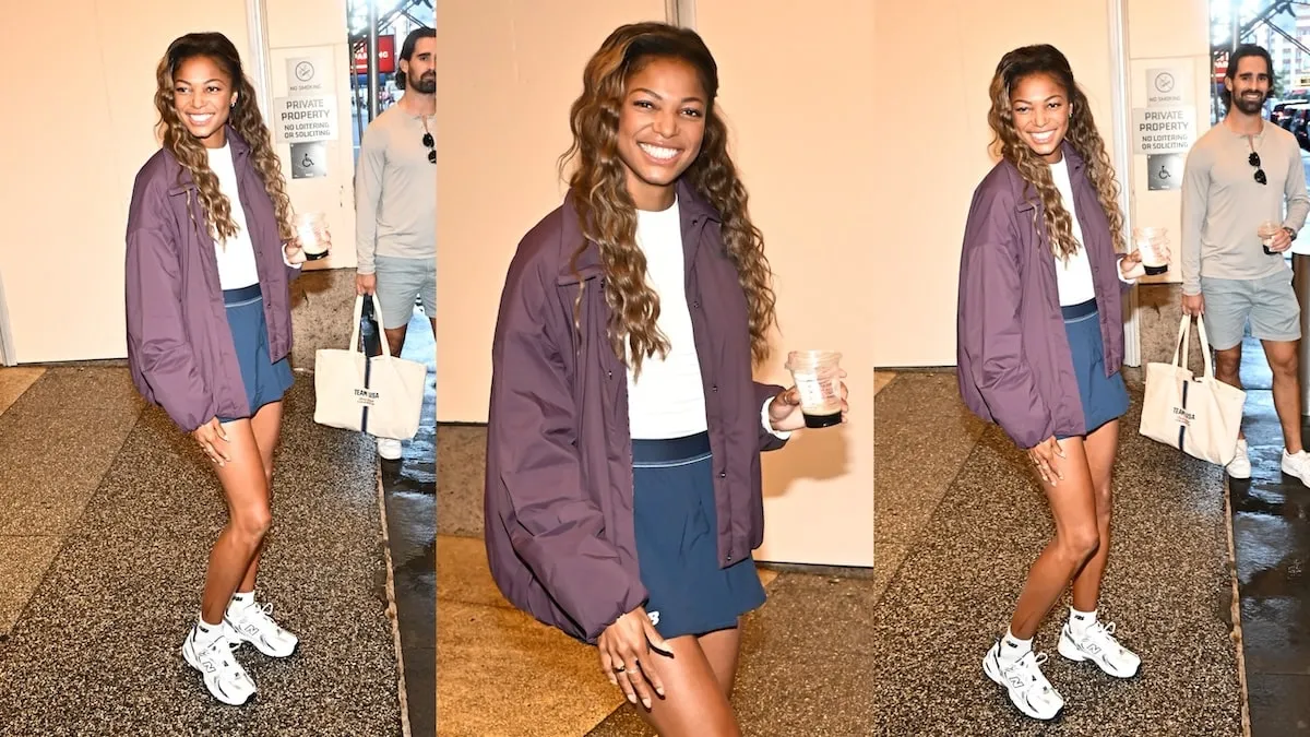 Wearing a purple jacket and navy shorts, Gabby Thomas exits CBS studios in NYC