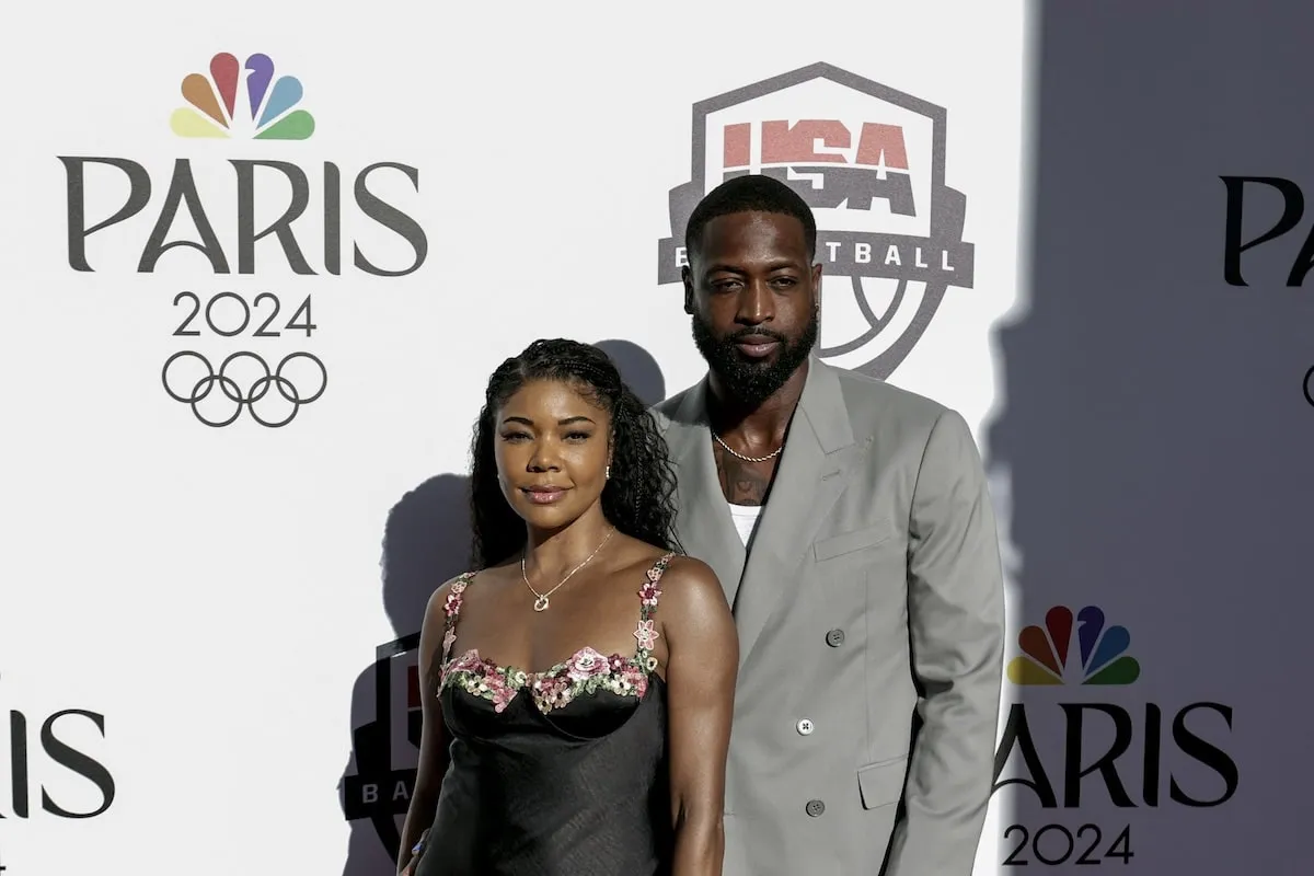 Wearing a black dress, Gabrielle Union stands with Dwyane Wade at NBA's Celebration of US Basketball in the Paris 2024 Olympics