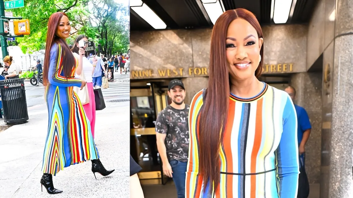 Wearing a striped dress, Garcelle Beauvais smiles for cameras outside of ABC Studios