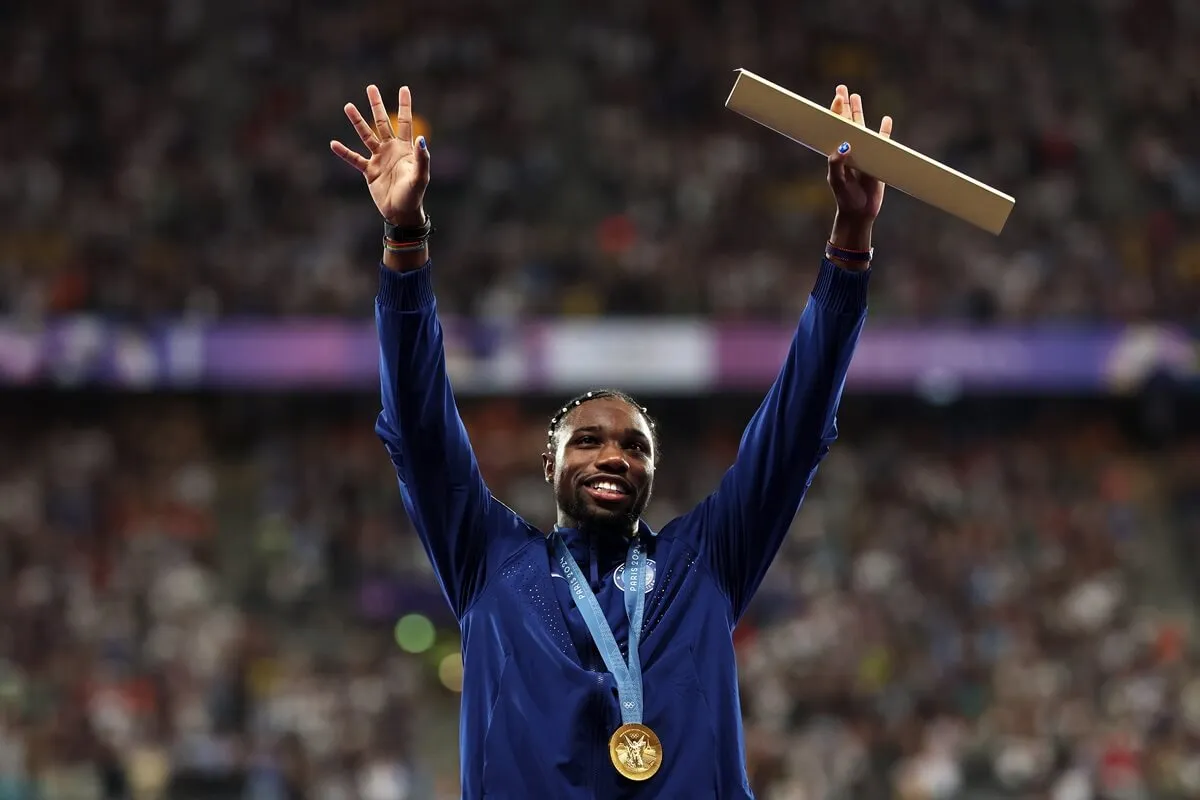 Gold medalist Noah Lyles celebrates on the podium during the Men's 100m medal ceremony