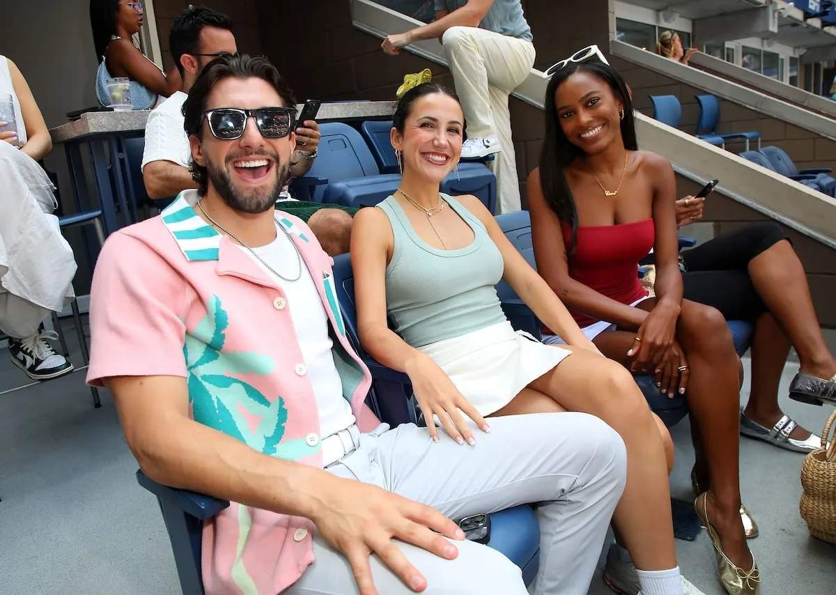 Reality stars Jason Tartick, Kat Stickler, and Ciara Miller sit in the stands at the U.S. Open