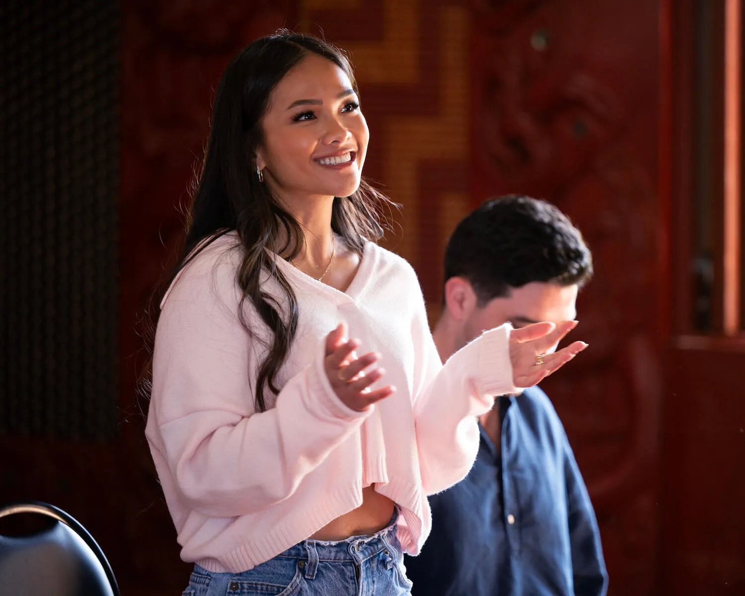 Jenn Tran wearing a white sweater and smiling on a group date in 'The Bachelorette' Season 21