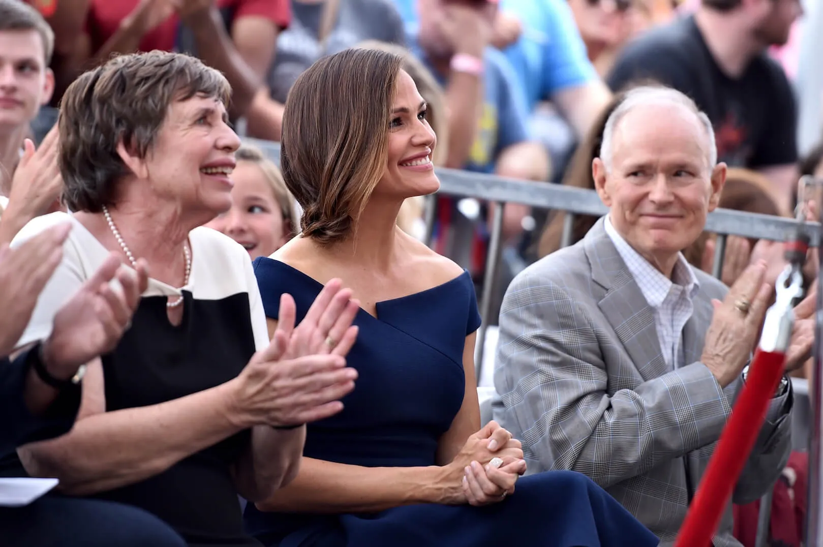 Patricia Garner, Jennifer Garner, and William Garner smiling and clapping at an event