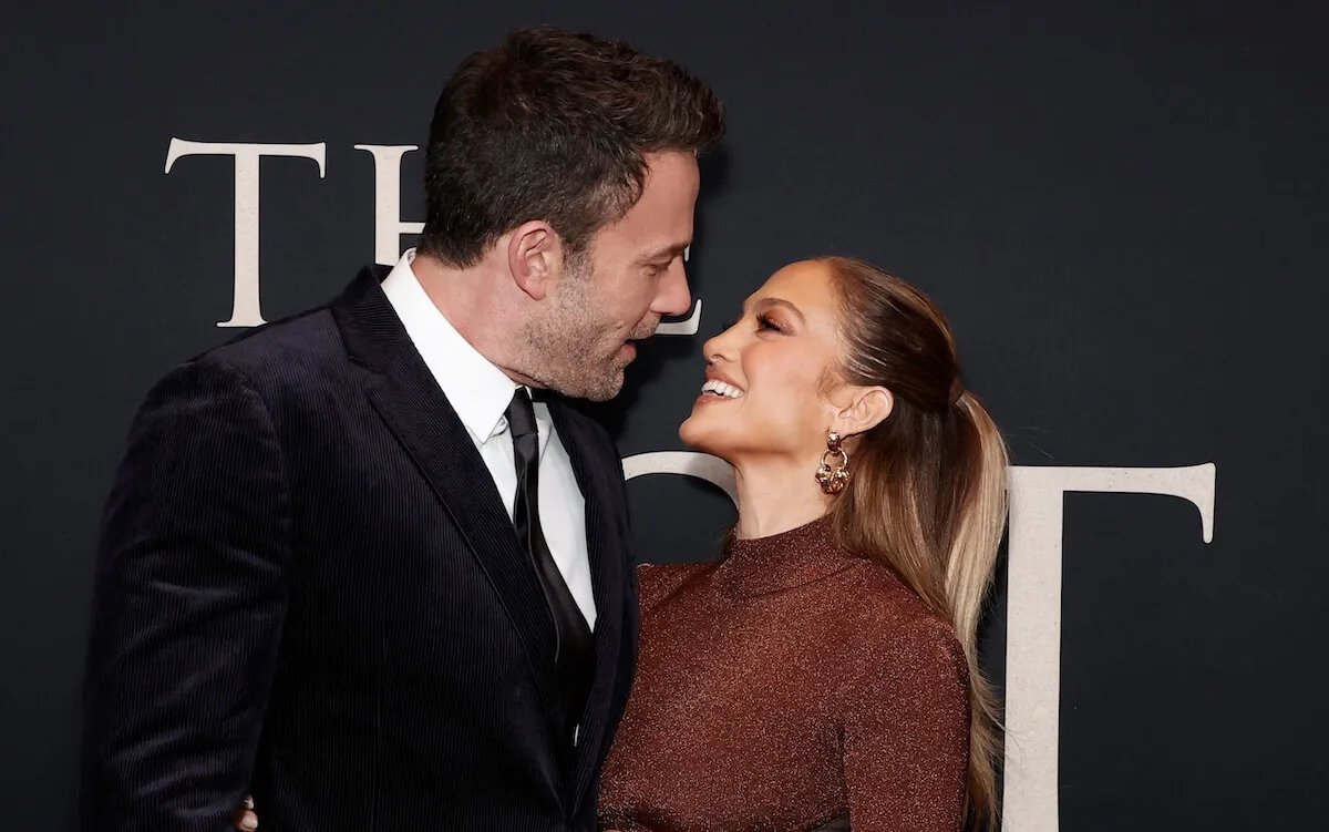 Ben Affleck and Jennifer Lopez smiling and looking into each other's eyes at a movie premiere in 2021