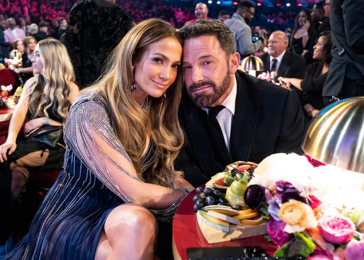 Jennifer Lopez and Ben Affleck sitting next to each other and smiling with their cheeks touching at the 65th Grammy Awards at Crypto.com Arena on Feb. 5, 2023, in Los Angeles