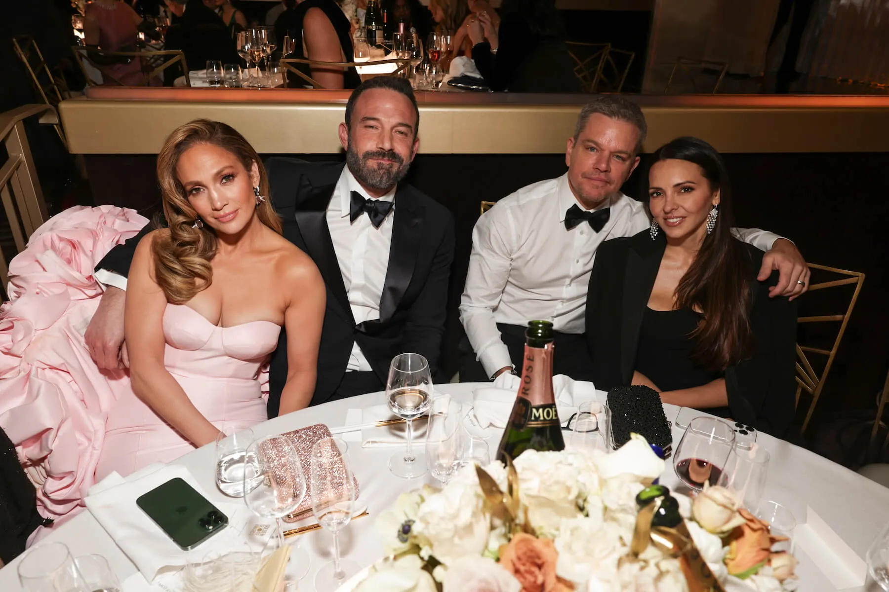 Jennifer Lopez, Ben Affleck, Matt Damon, and Luciana Damon sitting together at the Golden Globes