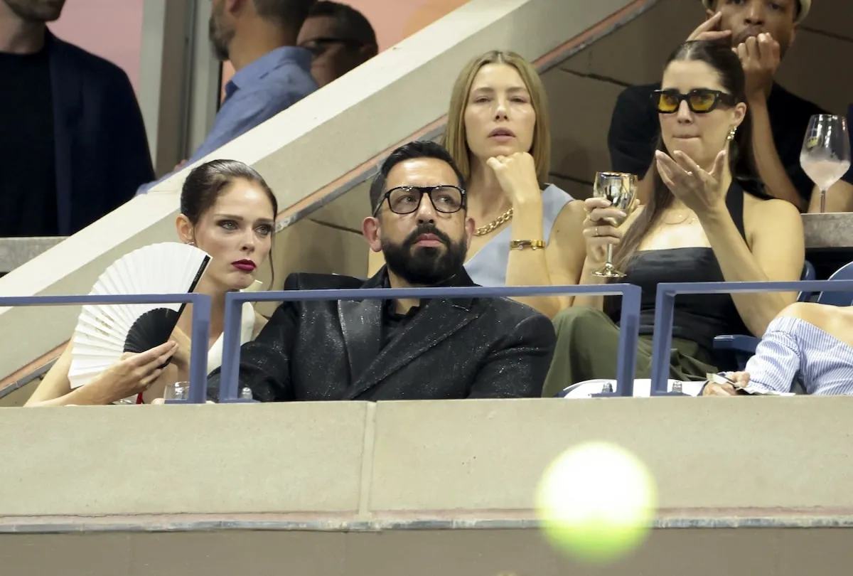 Wearing a light blue suit set, Jessica Biel and her friend watch the U.S. Open from her box seat