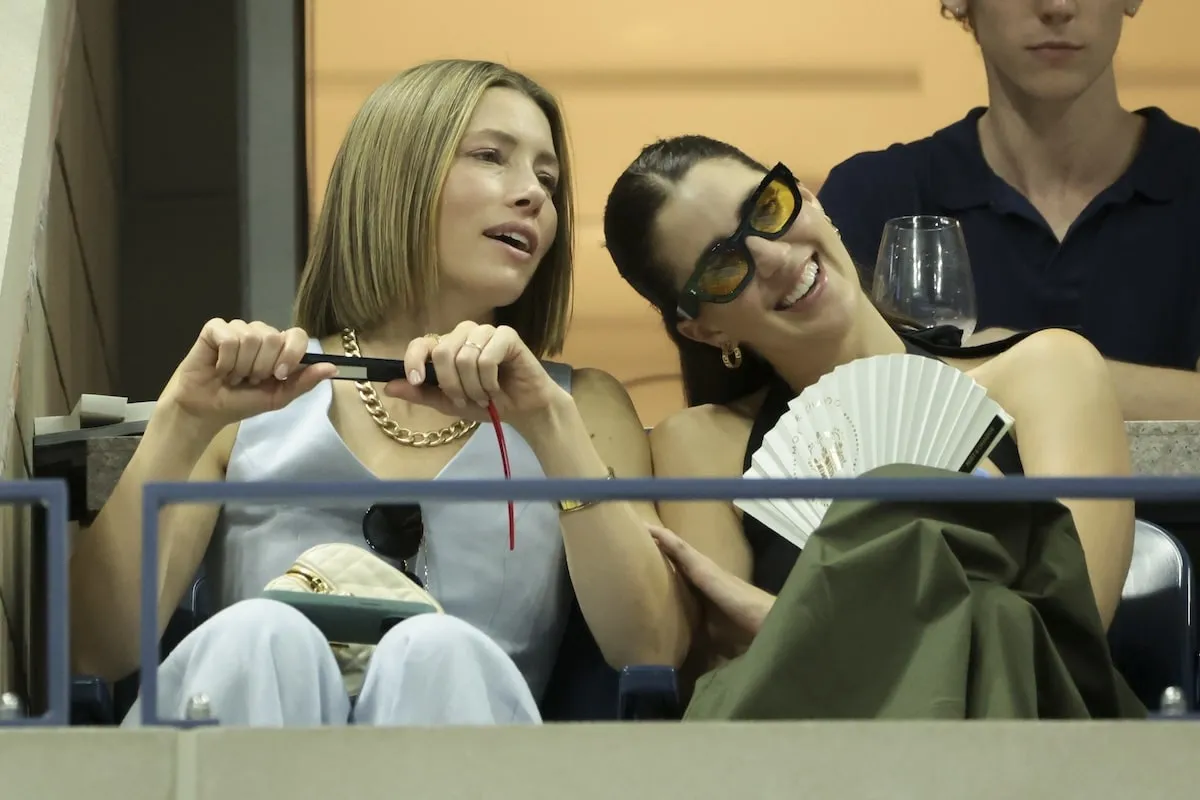 Wearing a light blue suit set, Jessica Biel and her friend watch the U.S. Open from her box seat