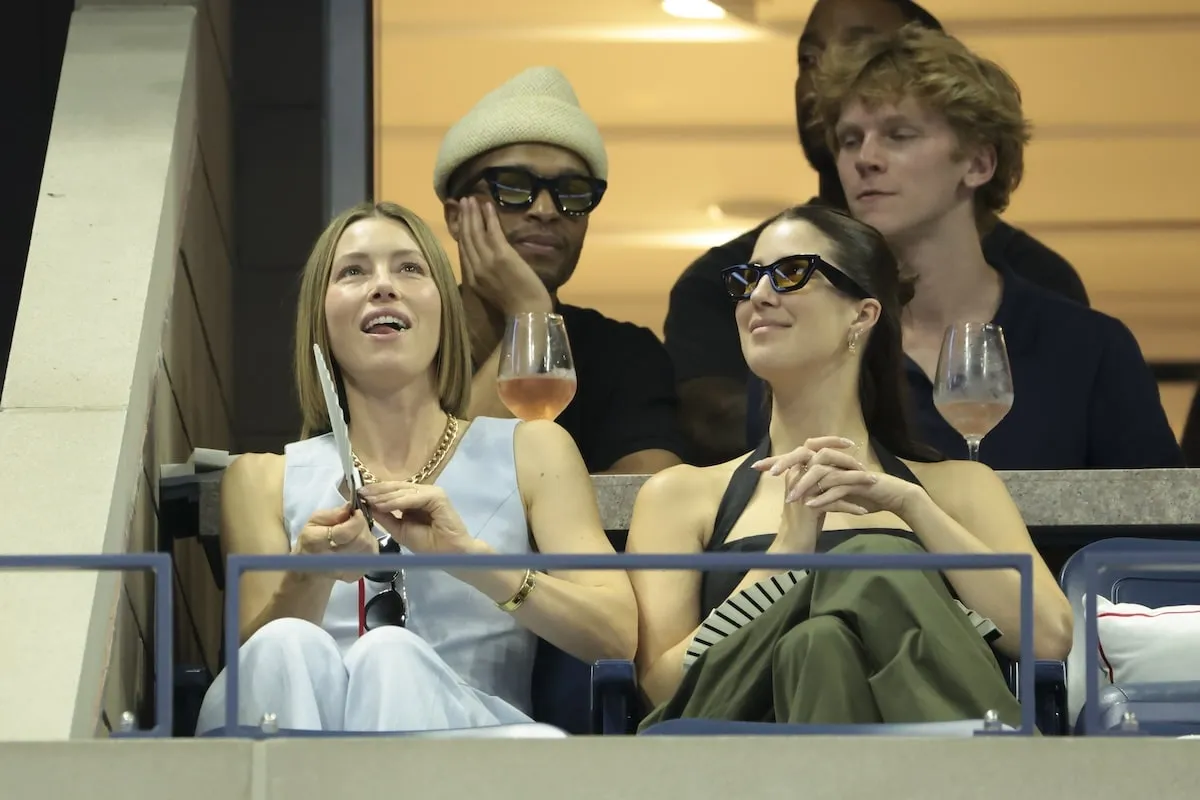 Wearing a light blue suit set, Jessica Biel and her friend watch the U.S. Open from her box seat