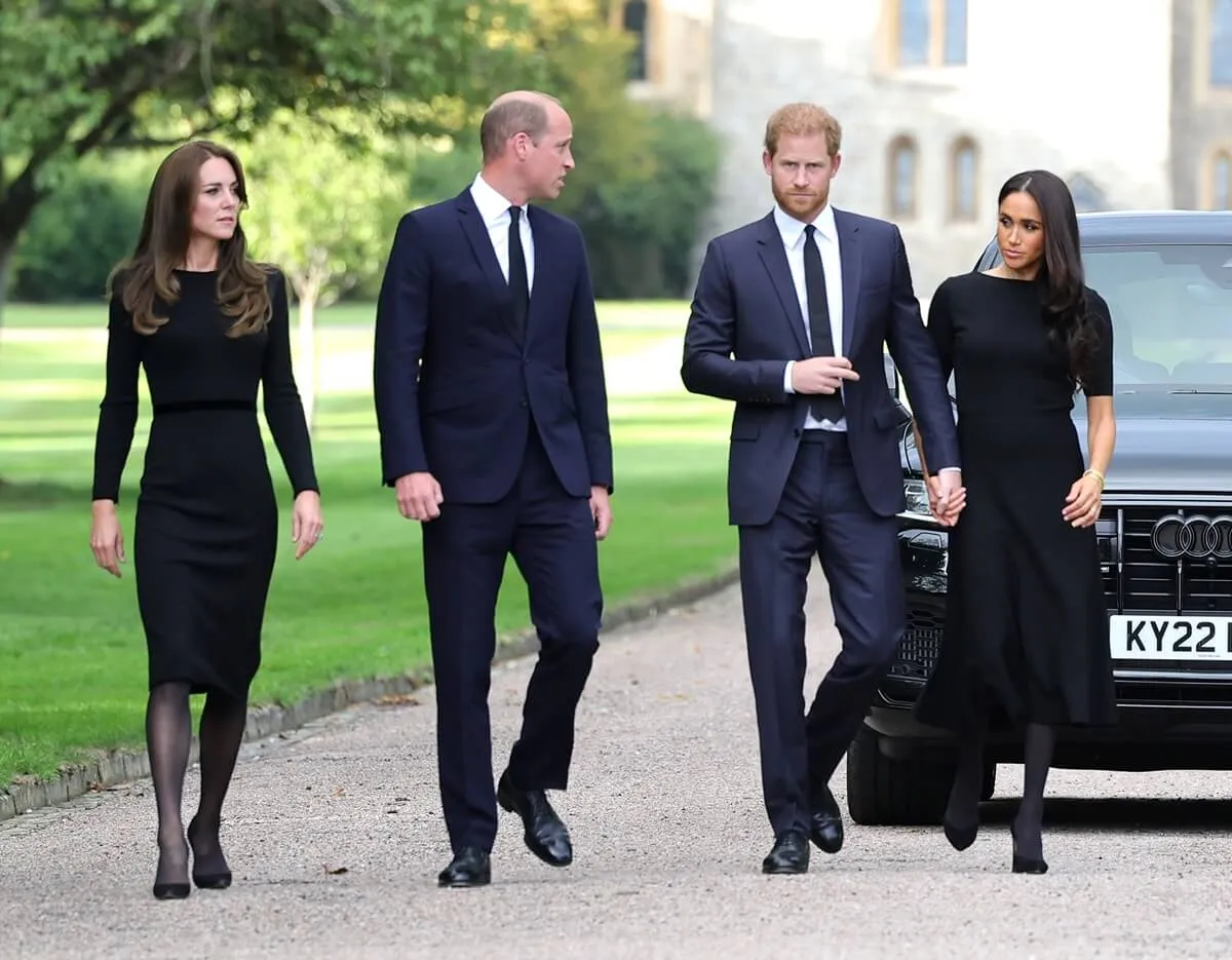 Kate Middleton, Prince William, Prince Harry, adn Meghan Markle on the Long Walk at Windsor Castle arrive to view flowers and tributes to Queen Elizabeth II