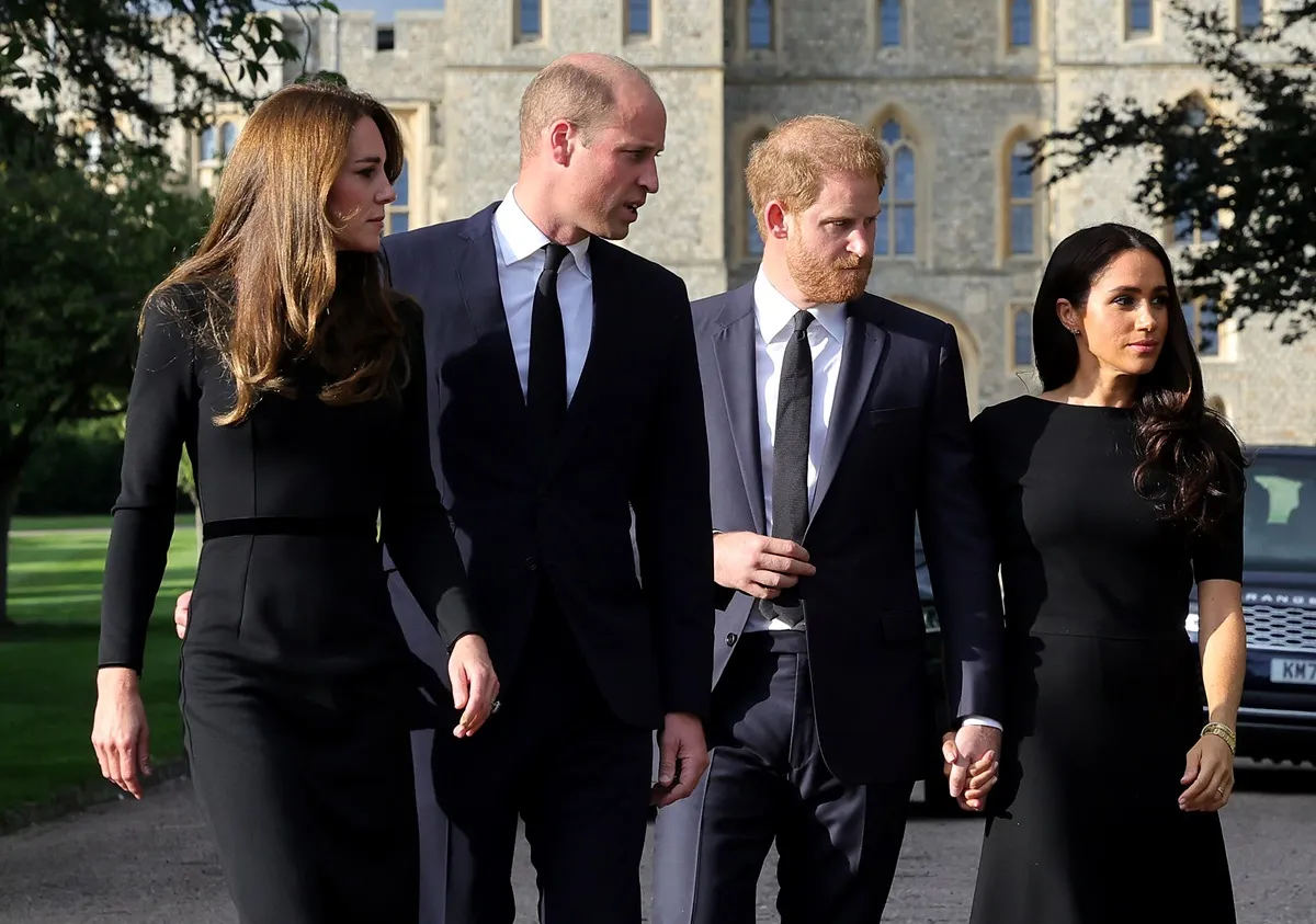 Kate Middleton, Prince William, Prince Harry, and Meghan Markle on the long Walk at Windsor Castle arrive to view flowers and tributes to HM Queen Elizabeth II