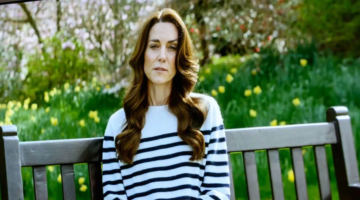 Kate Middleton shown on a TV screen while announcing her cancer diagnosis