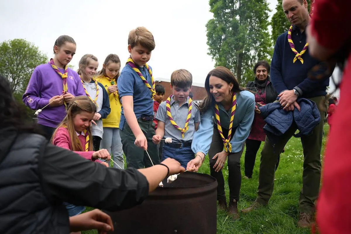 Kate Middleton, who is 'replicating' her childhood with Prince George, Princess Charlotte, and Prince Louis, stands with the kids and Prince William