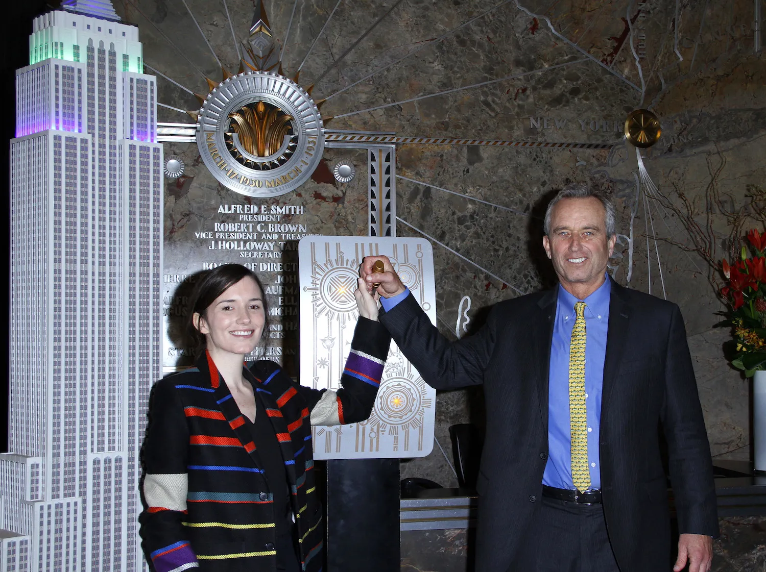 Kick Kennedy and Robert F. Kennedy Jr. holding raised hands at Riverkeeper's 50th Anniversary at The Empire State Building on April 13, 2016, in New York City