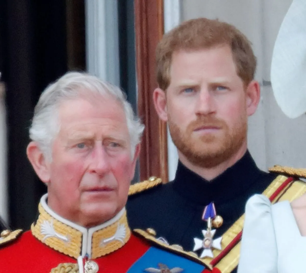 King Charles and Prince Harry standing on the balcony of Buckingham Palace during Trooping The Colour 2018