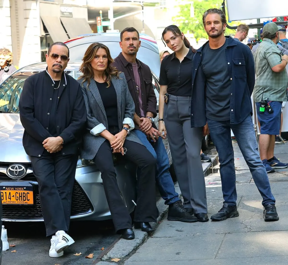 cast members of 'Law & Order: SVU' Season 26 leaning against a car