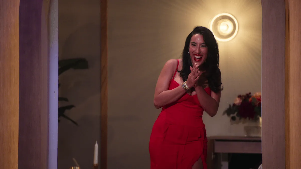 A woman in a red dress reacts to seeing her fiance on 'Love Is Blind: UK'