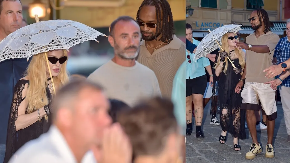 Wearing a black dress and carrying a white lacy umbrella, Madonna walks through Portofino, Italy, with her boyfriend Akeem Morris