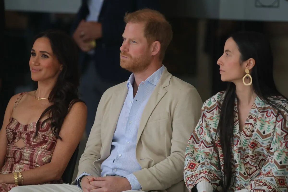 Meghan Markle and Prince Harry seated next to a translater at Delia Zapata Art Center in Bogota, Colombia