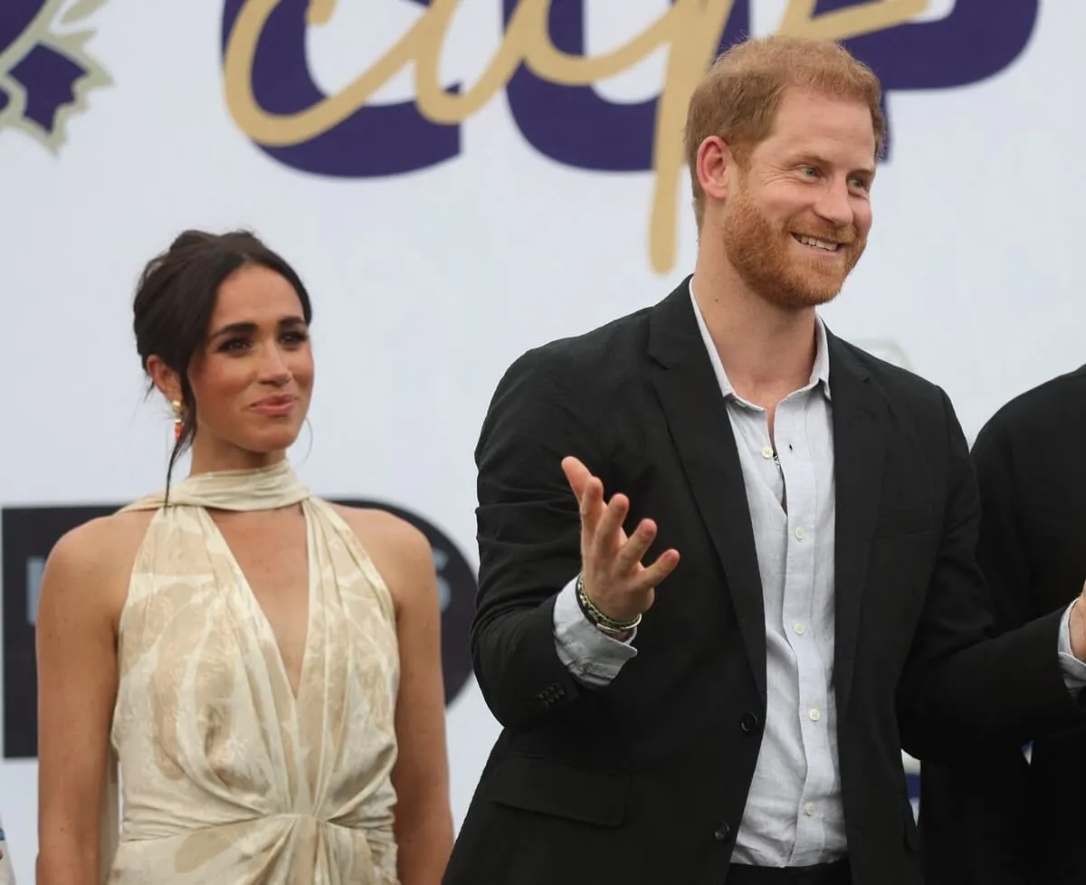 Meghan Markle and Prince Harry smile a photo after a charity polo game at the Ikoyi Polo Club in Lagos, Nigeria